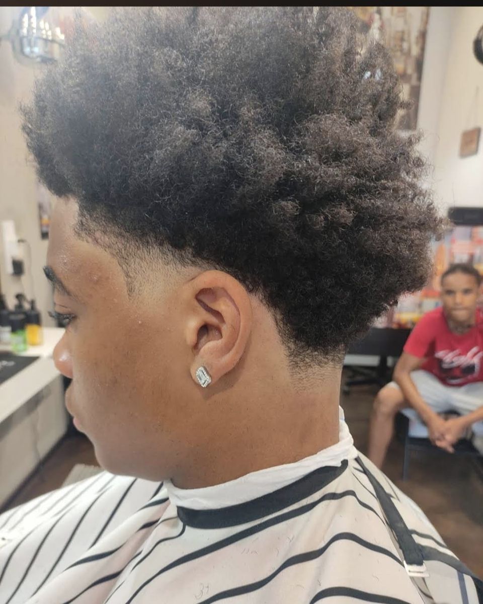 Curly afro haircut with taper fade