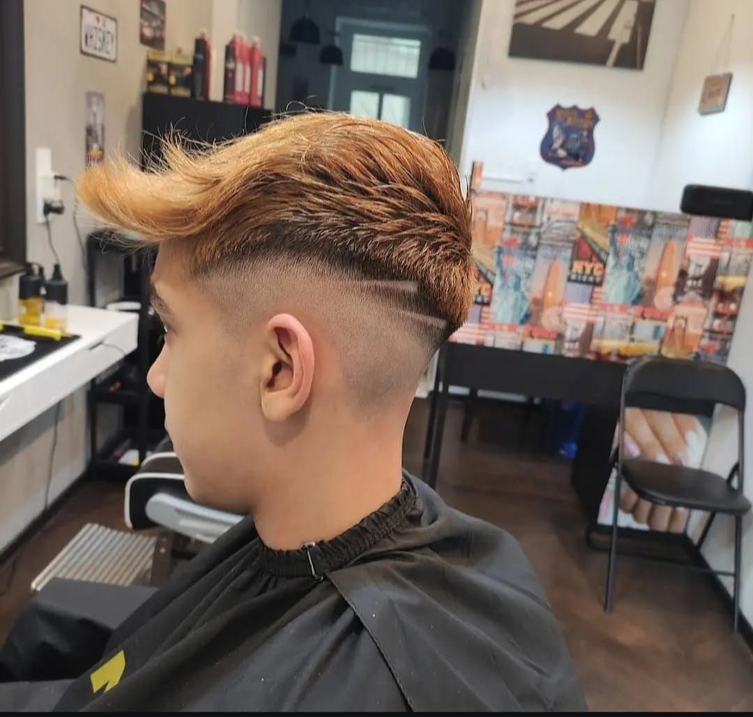 Copper-toned fade with a shaved side design