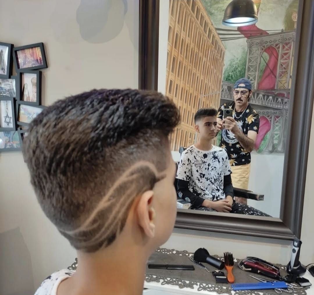 Kids' haircut with a wave shaved design on the side