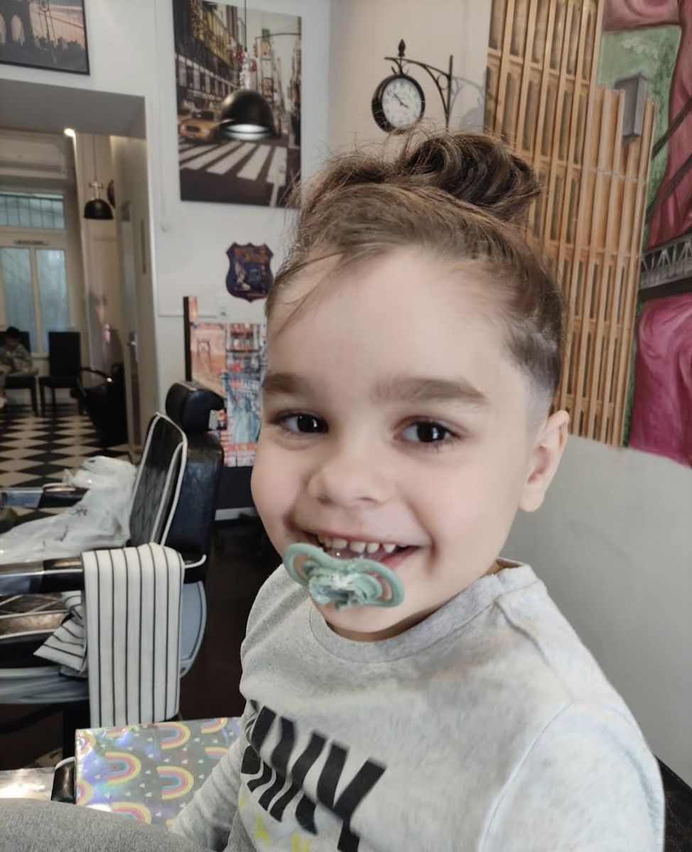Kids' top-knot haircut with a clean fade