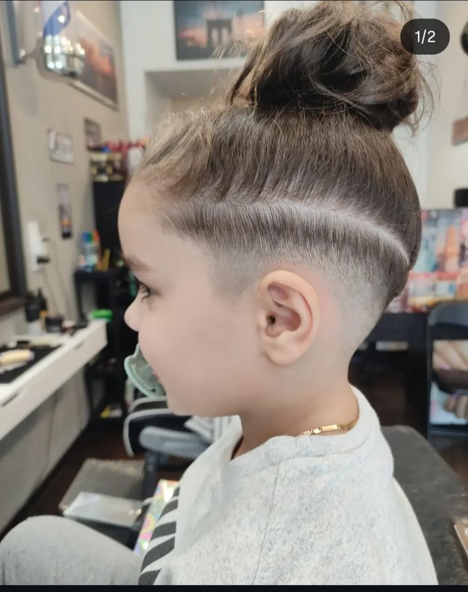 Kids' top-knot haircut with a shaved line design
