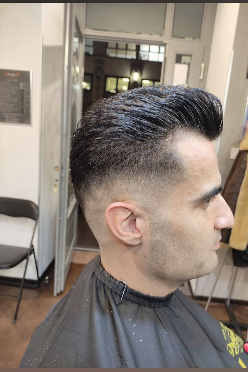 Slicked-back pompadour with fade
