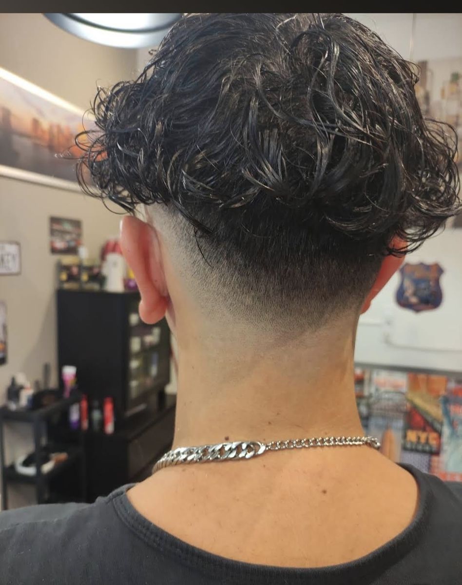 Tousled wavy haircut with fade