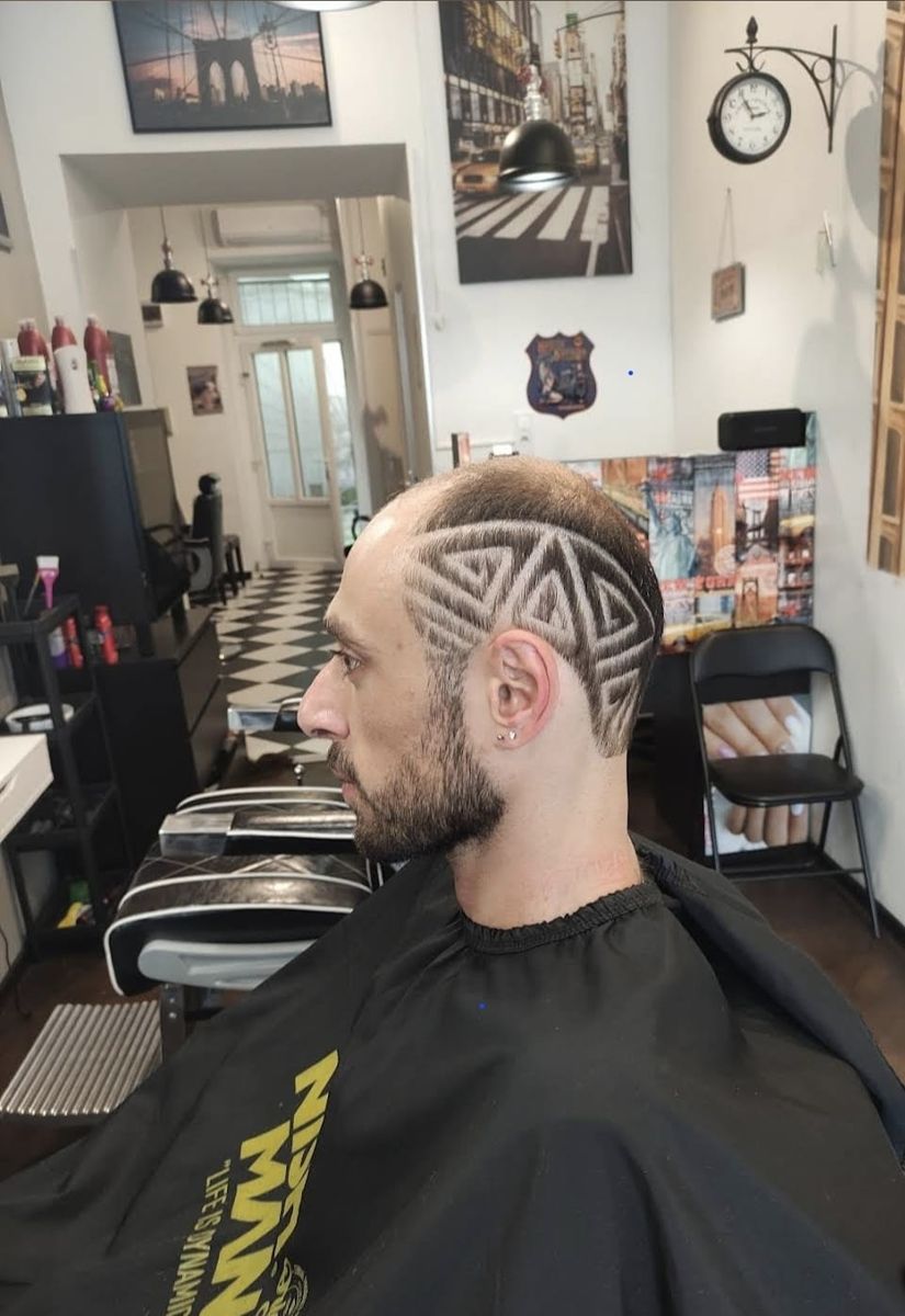 Buzzed haircut with a geometric triangle shaved design